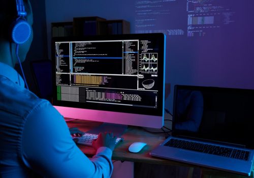 it-specialist-checking-code-computer-dark-office-night_1098-18699